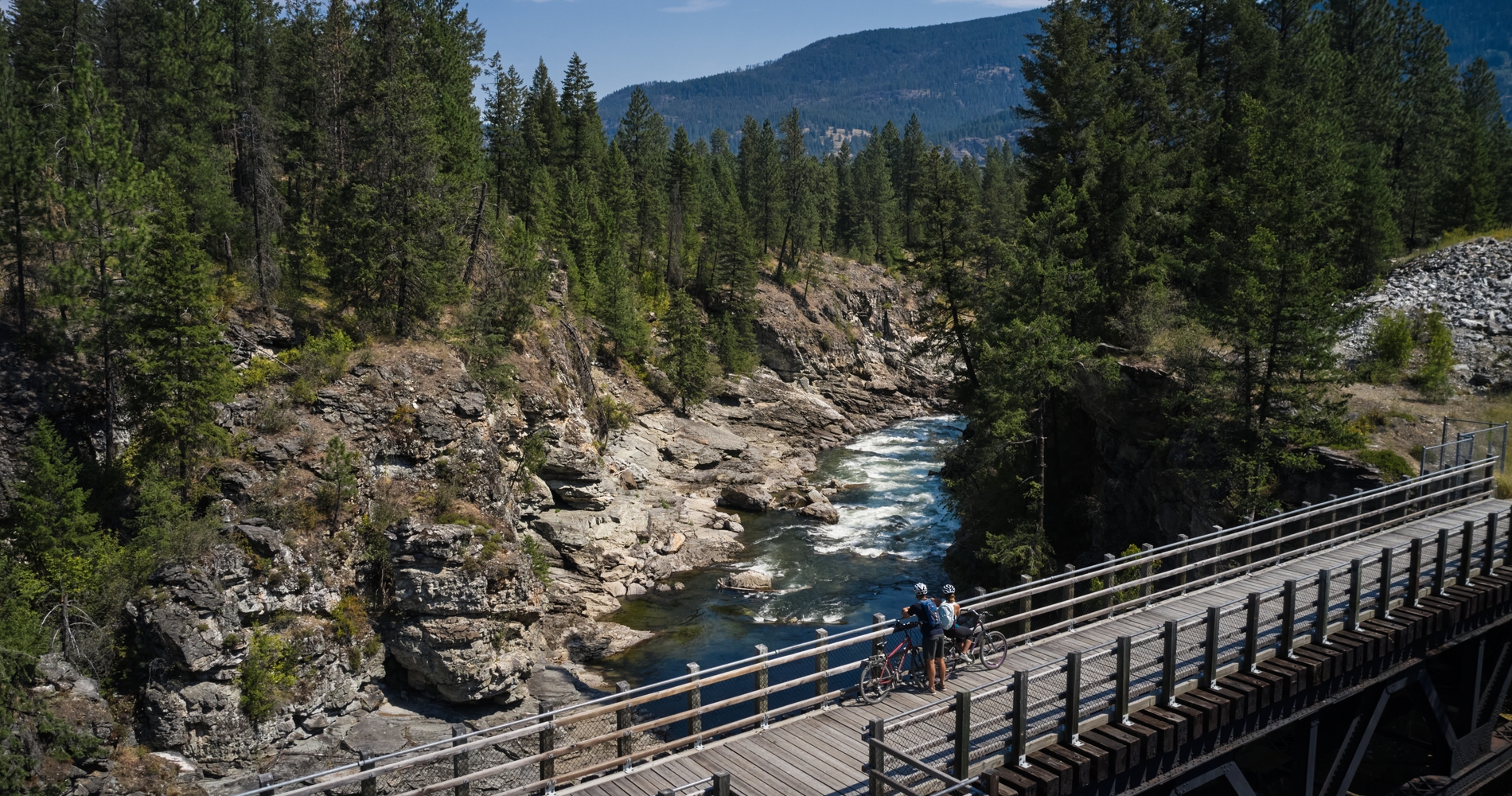 Biking on a trestle bridge on the Kettle Valley Trail in Christina Lake | Hubert Kang